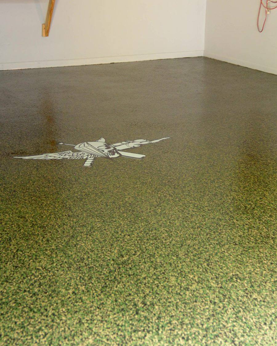 Finished chip flake garage floor with a custom firefighter stencil inlay